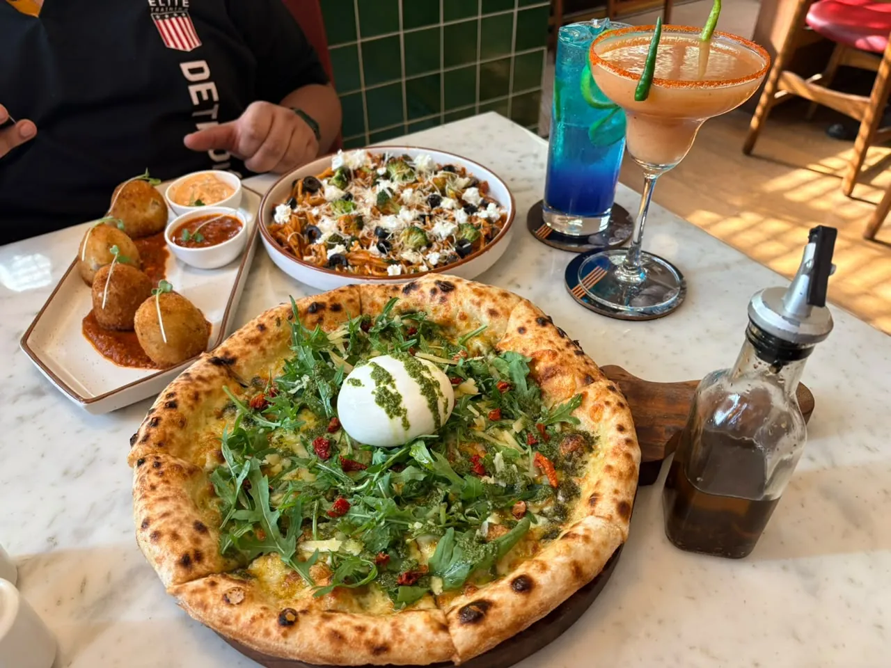 Pizza and cafe dishes shared across a table